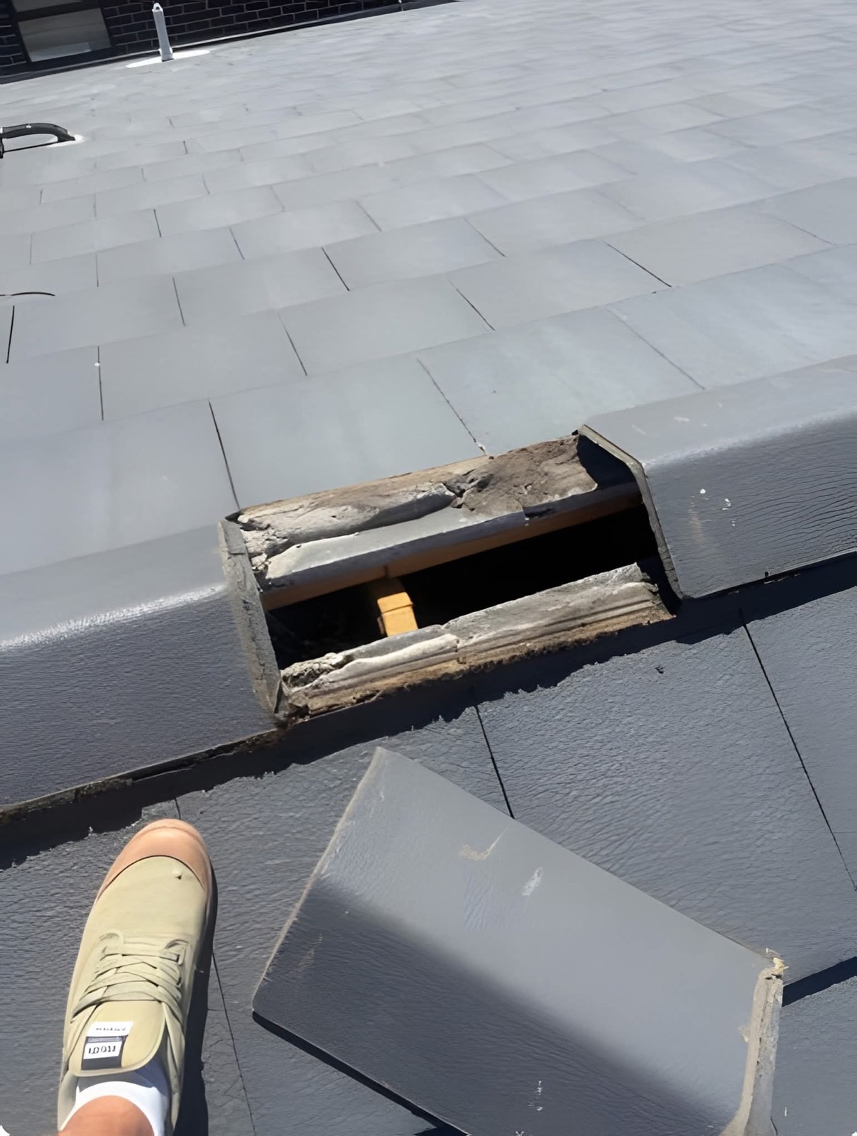 Roofer carrying out a ridge and roof repair