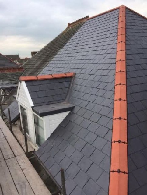 Slate roof with terracotta ridge tiles and dormer window